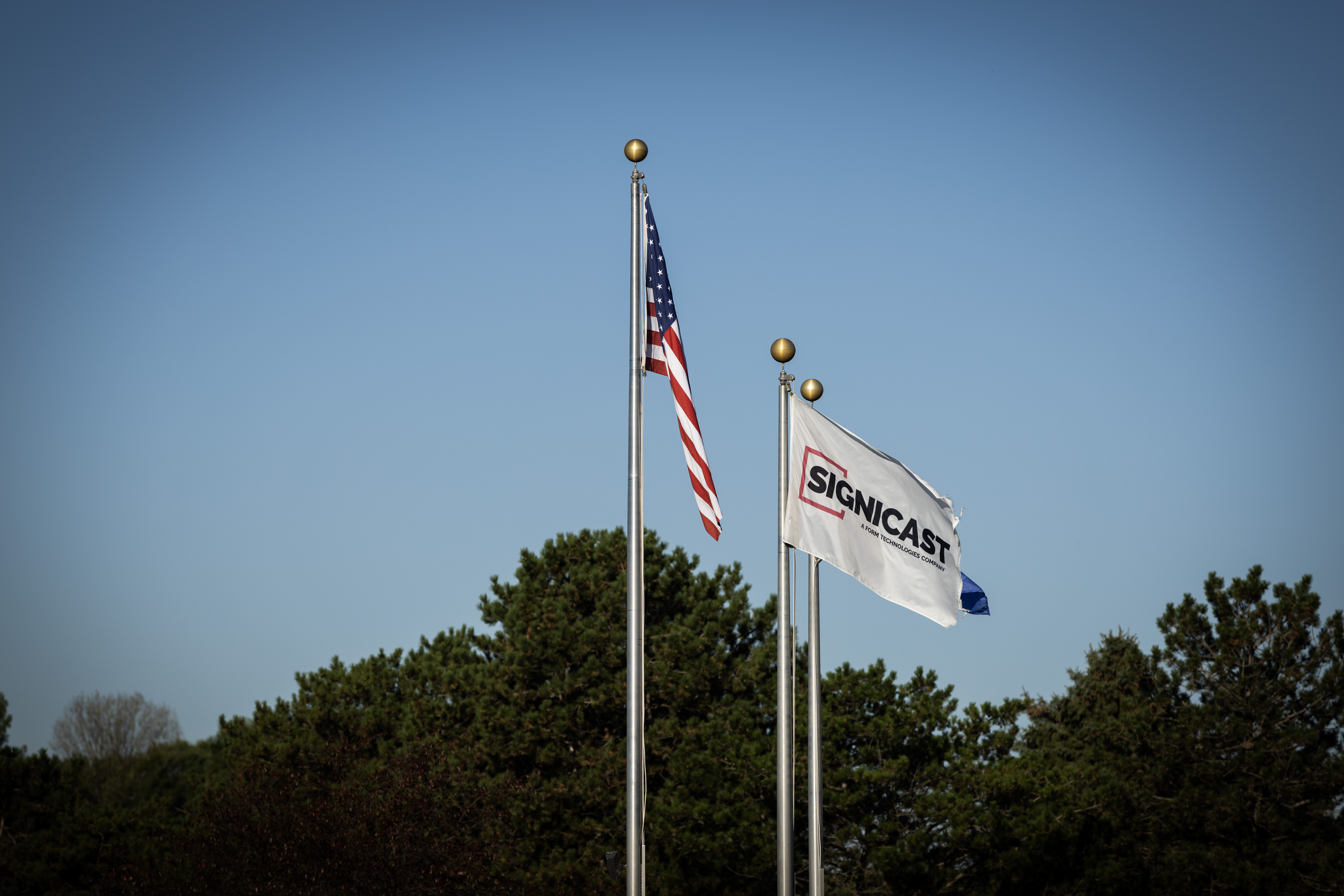 Flags in front of a Signicast facility